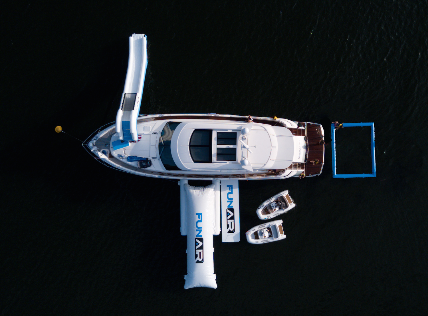 aerial shot of luxury yacht with inflatables on sides