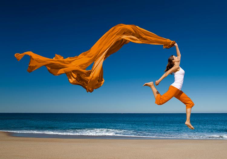 Woman in a beach jumping